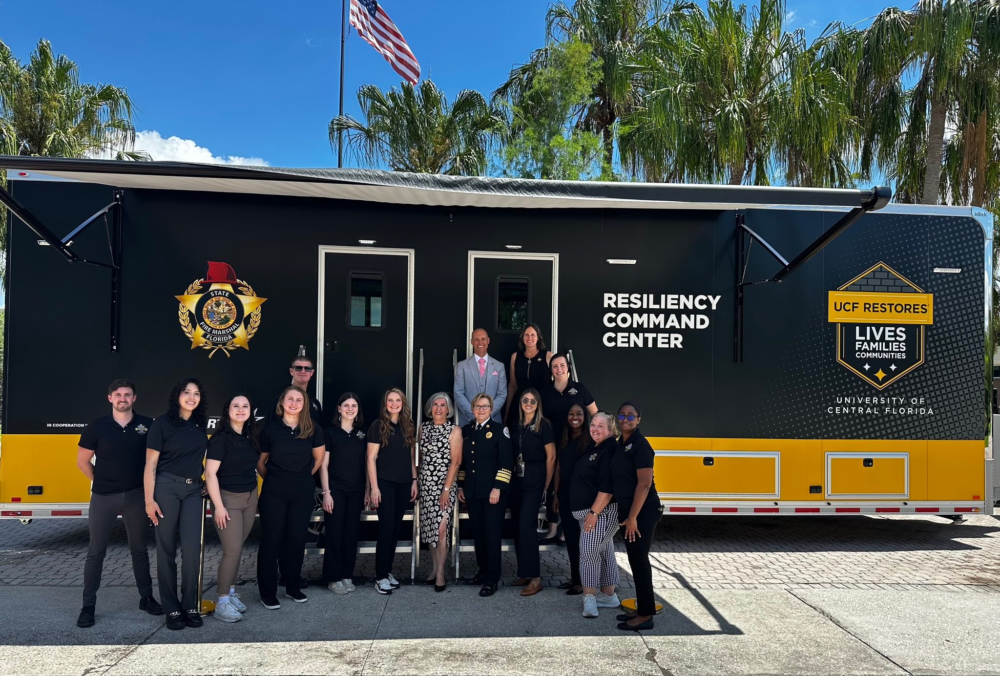 The UCF RESTORES team, alongside Florida Division of State Fire Marshal Director Joanne Rice, poses in front of the newly unveiled UCF RESTORES Resiliency Command Center on May 14, 2025.